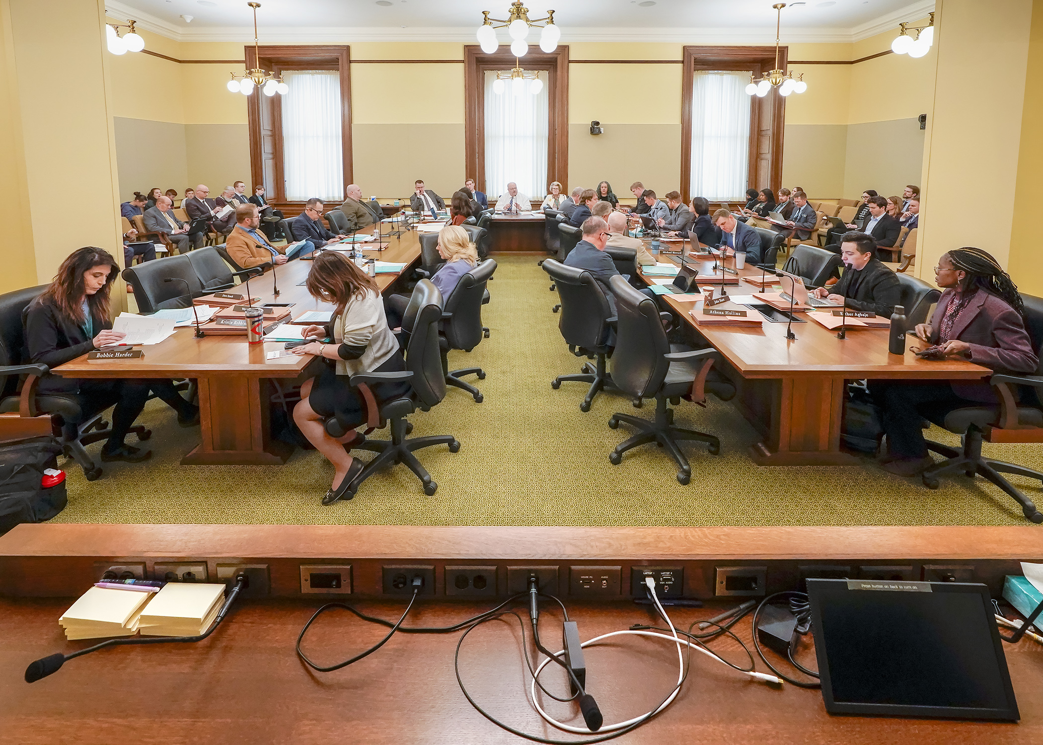 The House Taxes Committee listens March 11 as nonpartisan staff walk through a bill that would modify expiration of the pass-through entity tax. (Photo by Andrew VonBank)